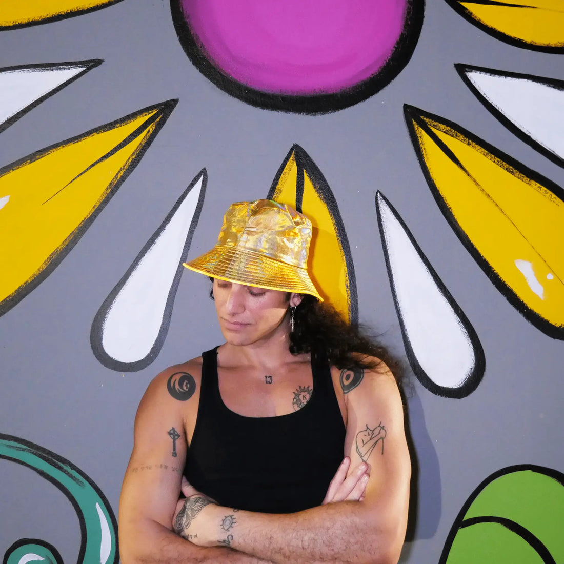 male model wearing holo gold LED bucket hat festival outfit